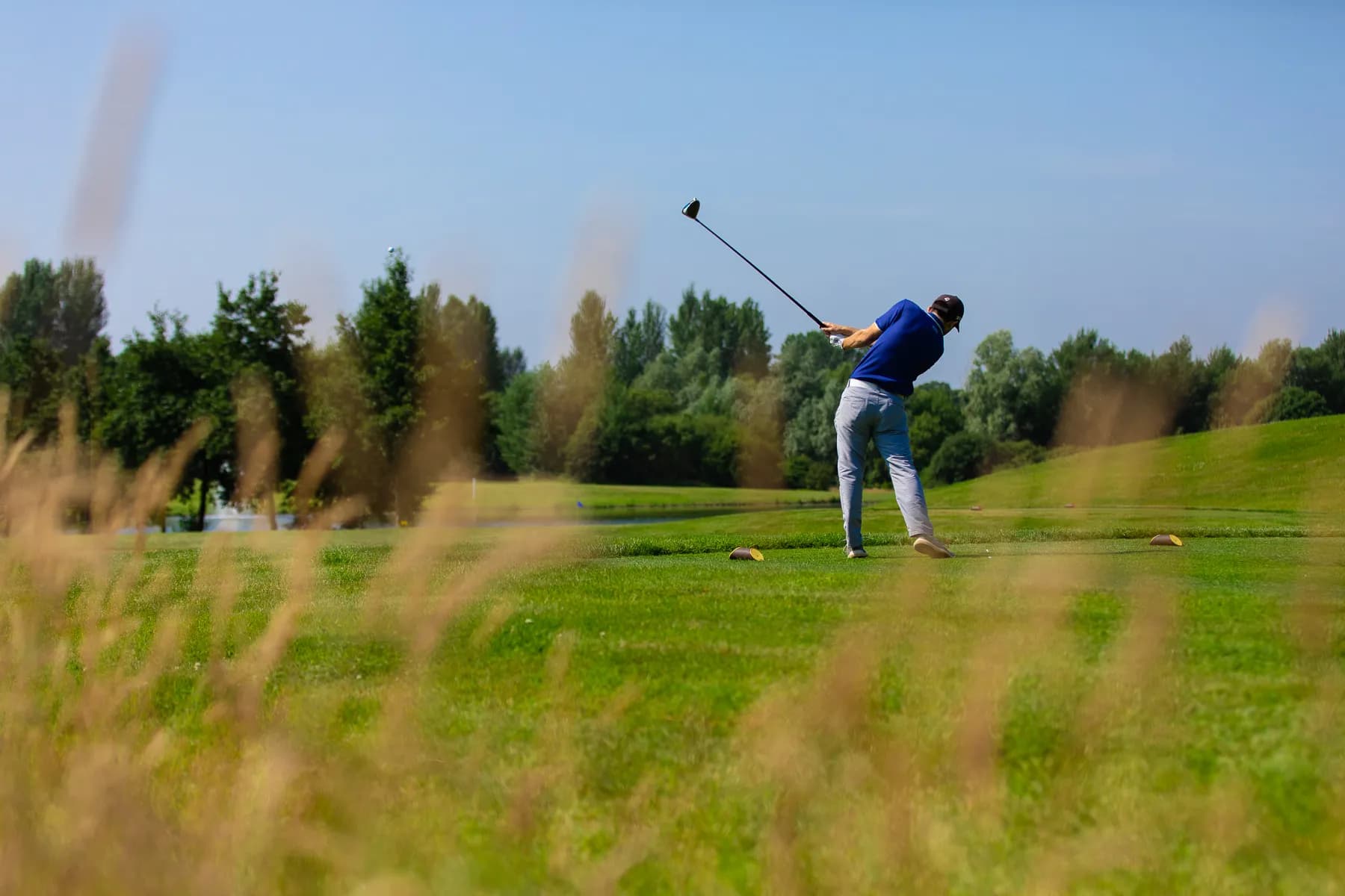 A golfer driving from the tee at Stonebridge Golf Club